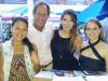 Rick Vach, owner of Longboard Cafe, is proud to pose with his lovely hostesses Adel, Rachael & Lucy.